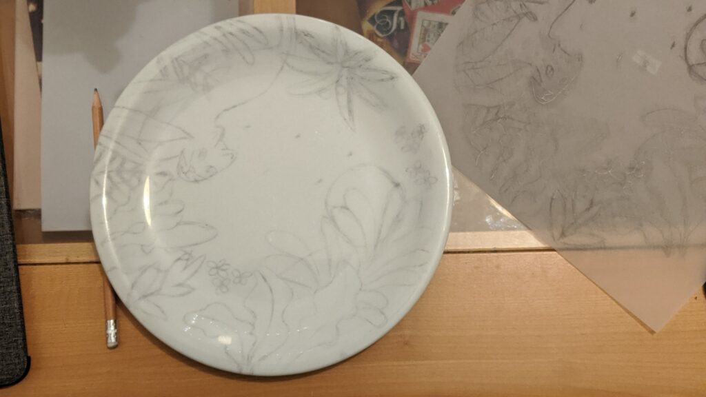 Transferred drawing — Pencil drawing transferred onto a blank ceramic plate before painting.