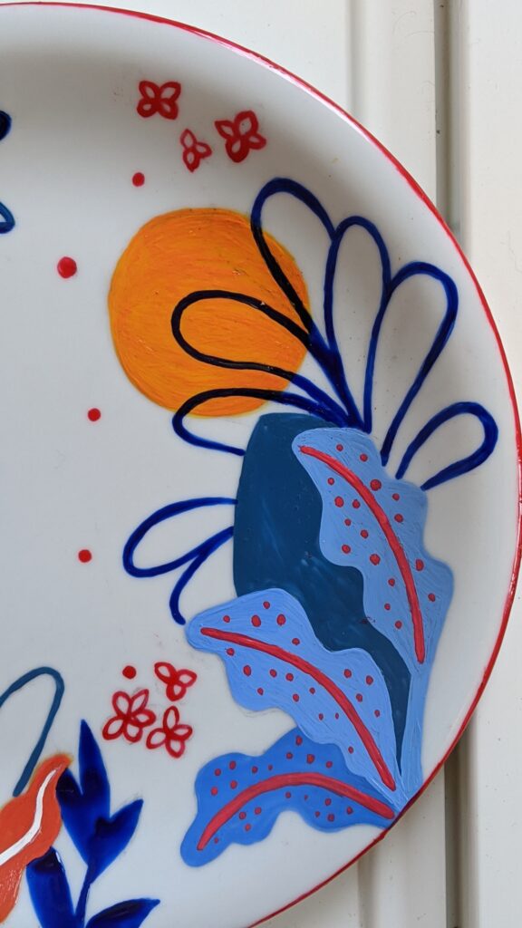 Colorful ceramic plate hand-painted with a tropical tiger illustration.